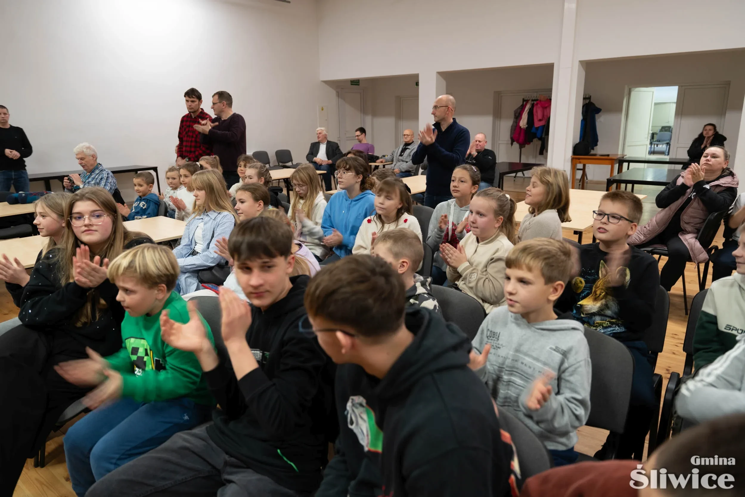 zebrani na sali klaszczą
